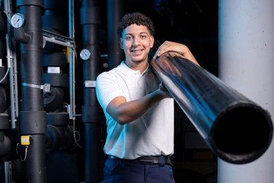 Lehrling Haustechnik Junger Mann mit Haustechnik Rohr